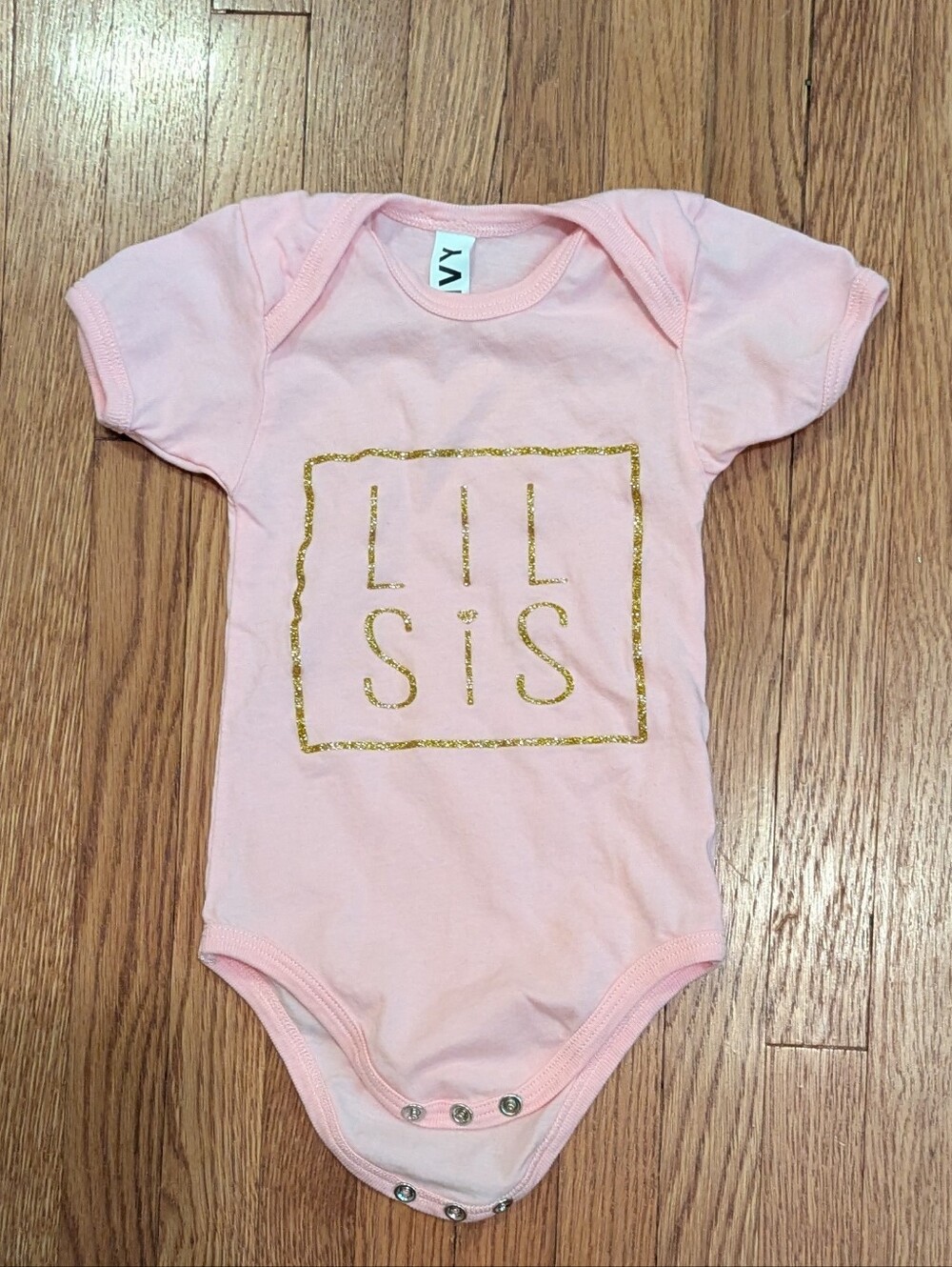 'LIL SIS' Pink One-Piece Bodysuit with Gold Print